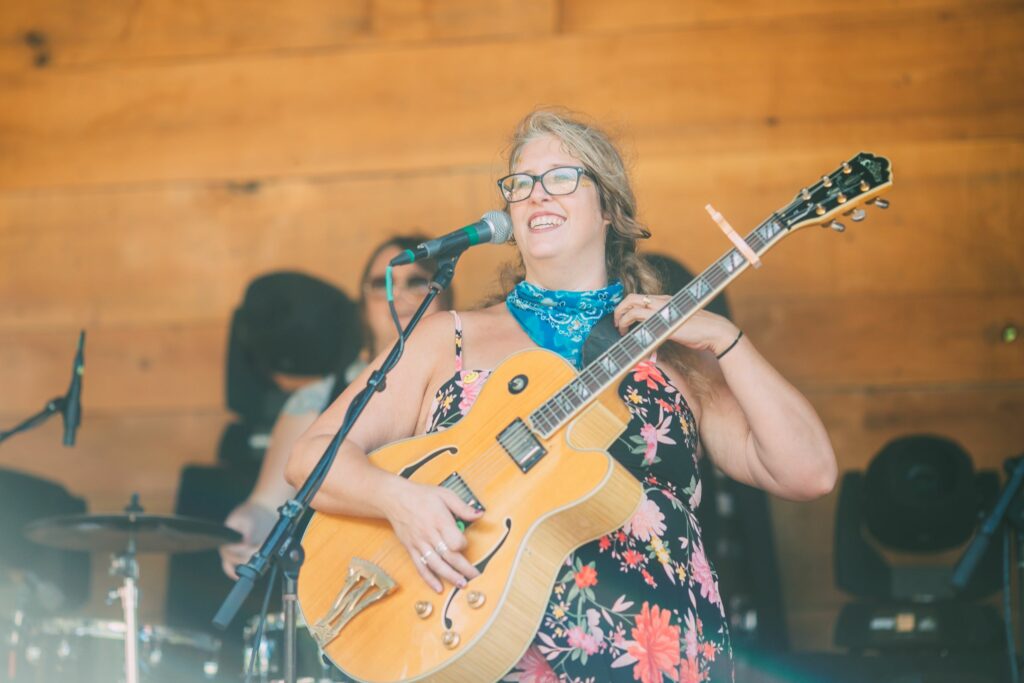 Woman on stage playing guitar