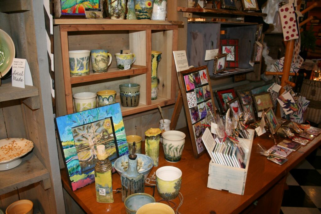local arts and crafts on display. paintings, pottery.
