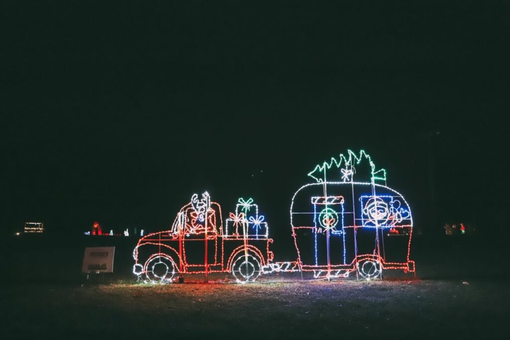 Holiday light display that looks like a light up car with reindeer and packages